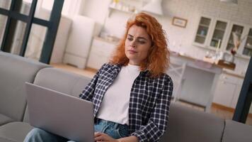 Pensive thinking Caucasian woman thoughtful girl female lady think idea working laptop using computer online internet ponder problem solution trouble at home couch decide freelance failure difficulty video