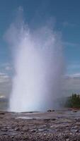 Geysir destrict in Iceland. The Strokkur Geyser erupting at the Haukadalur geothermal area, part of the golden circle route, in Iceland. Vertical footage video