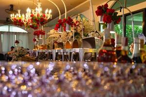 A long table with many glasses and bottles photo