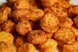 A close up of a pile of fried cheese balls photo