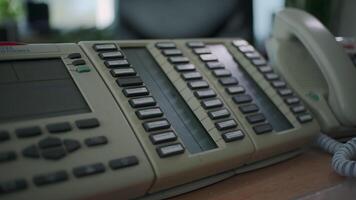 Landline phone at the factory workshop. Clip. Close up of a man hand pressing buttons on a stationary push button telephone. video