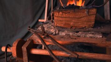 Working with split iron. Media. A man is a blacksmith who forges iron on the street at a split temperature. video