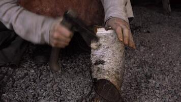 Working with split iron. Media. A man is a blacksmith who forges iron on the street at a split temperature. video
