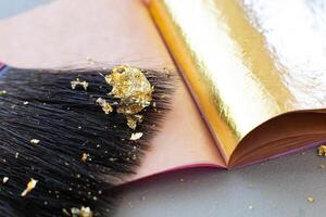 Gilding theme with a leaf of beaten gold and blade photo