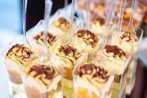 Delicious Layered Desserts in Clear Cups Displayed at a Festive Celebration Event photo