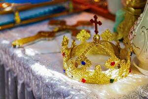 Golden Crown With Colorful Jewels Displayed on a Decorated Altar in a Serene Setting. photo