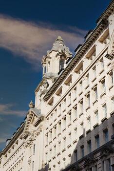 Exterior of a Tall White Building with Windows photo