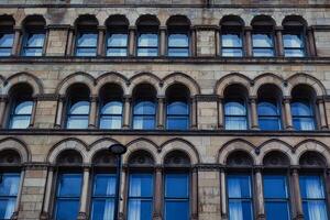 Stone Building Facade with Arched Windows photo