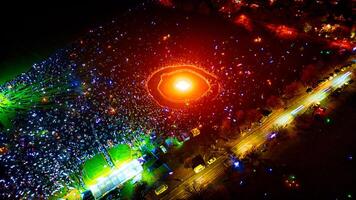 Aerial Nighttime View of Crowd Gathering Around Bonfire photo
