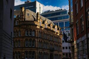 City Street with Historic Buildings and Modern Glass Structure photo