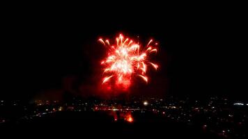 Red Firework Display Over City Skyline photo