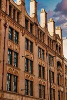 Brick Building with Ornate Detailing and Chimneys photo
