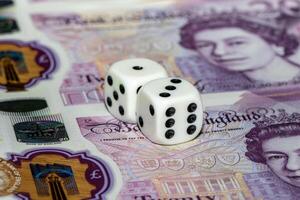 Two Dice Resting on a Twenty Pound Note photo