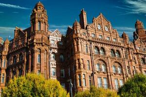 Red Brick Building with Ornate Details and Clock Face photo