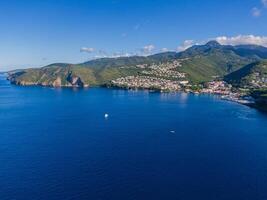 Drone view of the Bay in front of Case-Pilote with diving boats in the ocean, Martinique, West Indies, France photo