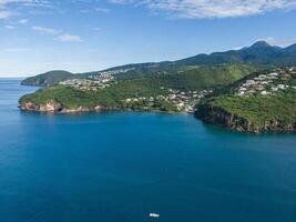 Aerial view of a coast near Case-Pilote coast with a diving boat in the caribean ocean, West Indies, Martinique, France photo