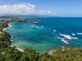 Surfers enjoying Entre-deux surf spot at Anse l'Etang beach, Tartane, Martinique, West Indies, France photo