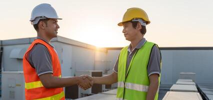 Engineers team shake hand after install air condition systems on site. Contractor and inspector inspection construction during project. civil Forman check quality assurance control. Audit, inspect photo