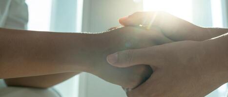 psychiatrist hold hand support each while discussing family issues. doctor encourages and empathy man suffers depression. psychological, save divorce, Hand in hand together, trust, care photo