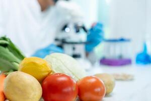 Scientist check chemical food residues in laboratory. Control experts inspect quality of fruits, vegetables. lab, hazards, ROHs, find prohibited substances, contaminate, Microscope, Microbiologist photo