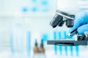 Scientist analyze biochemical samples in advanced scientific laboratory. Medical professional use microscope look microbiological developmental of viral. Biotechnology research in science lab. photo