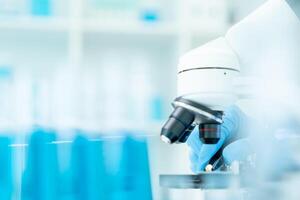 Scientist analyze biochemical samples in advanced scientific laboratory. Medical professional use microscope look microbiological developmental of viral. Biotechnology research in science lab. photo
