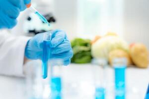 Scientist check chemical food residues in laboratory. Control experts inspect quality of fruits, vegetables. lab, hazards, ROHs, find prohibited substances, contaminate, Microscope, Microbiologist photo