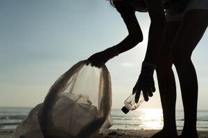 Save ocean. Volunteer pick up trash garbage at the beach and plastic bottles are difficult decompose prevent harm aquatic life. Earth, Environment, Greening planet, reduce global warming, Save world photo