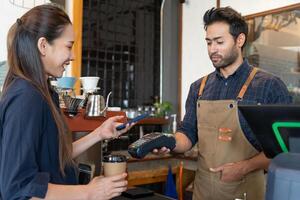Woman use smartphone to scan QR code for order menu in cafe restaurant with a digital delivery. Choose menu and order accumulate discount. E wallet, technology, pay online, credit card, bank app. photo