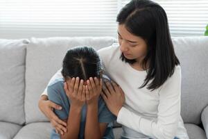 problem in family. mother hug and encourages, feel stressed from the parents quarrel. child is have mental problem. quarrels, violence, depression, suicide, discouragement, social problem photo