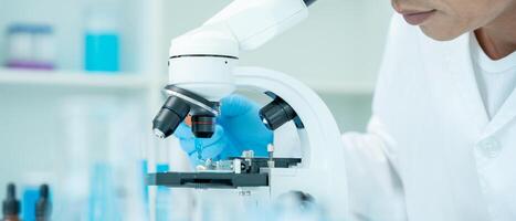 Scientist analyze biochemical samples in advanced scientific laboratory. Medical professional use microscope look microbiological developmental of viral. Biotechnology research in science lab. photo