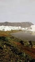 gigantic Ice block structures on the black sand by the sea shore video