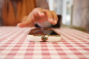 man hand picking up smart phone mobile to receive a call photo