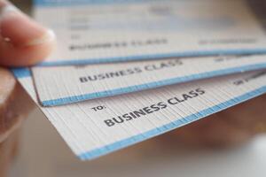 A comprehensive collection of valuable Business Class Flight Tickets securely held in a hand photo