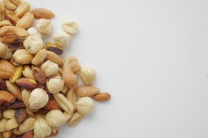 An assortment of nuts on a white background, showcasing healthy snack options for diverse tastes photo