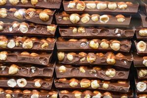 Indulge in these Delicious Chocolate Bars with Hazelnuts Stacked Neatly for a delightful experience photo