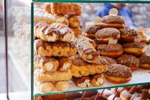 A beautifully arranged assortment of delicious pastries and donuts on display at the bakery photo