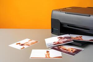 Printer printing colorful photos of people close up, yellow background