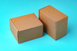 A collection of cardboard boxes arranged on a bright blue surface photo