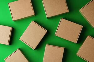 Brown cardboard boxes arranged on a vibrant green surface photo