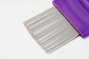 Lice comb with multiple fine teeth for effective lice removal and scalp care photo