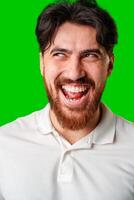 A man with a beard smiles confidently against a bright green background photo