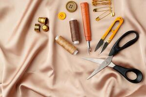 Sewing tools and materials arranged on soft fabric showcasing essential crafting supplies for creative projects photo