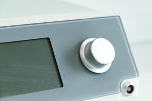 modern electronic control panel featuring a large rotary knob and digital display photo