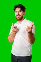 Smiling man gestures playfully with finger guns against a vibrant green background photo