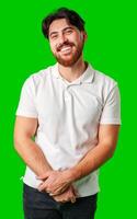 A man with a beard smiles confidently against a bright green background photo