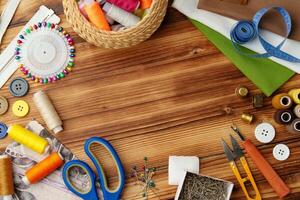 Crafting tools and materials arranged on a wooden table for sewing projects photo