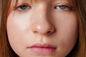 portrait of a young person with natural skin and calm expression during daylight photo