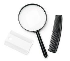 A magnifying glass and lice comb placed side by side on a clean white background photo