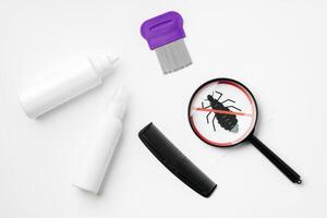 Tools for inspecting and treating lice infestations at home with a magnifying glass and a comb photo